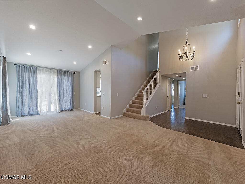 1902 Rambling Road Simi Valley, CA 93065 - Photo 36 of 67 a view of a hallway with stairs and a chandelier