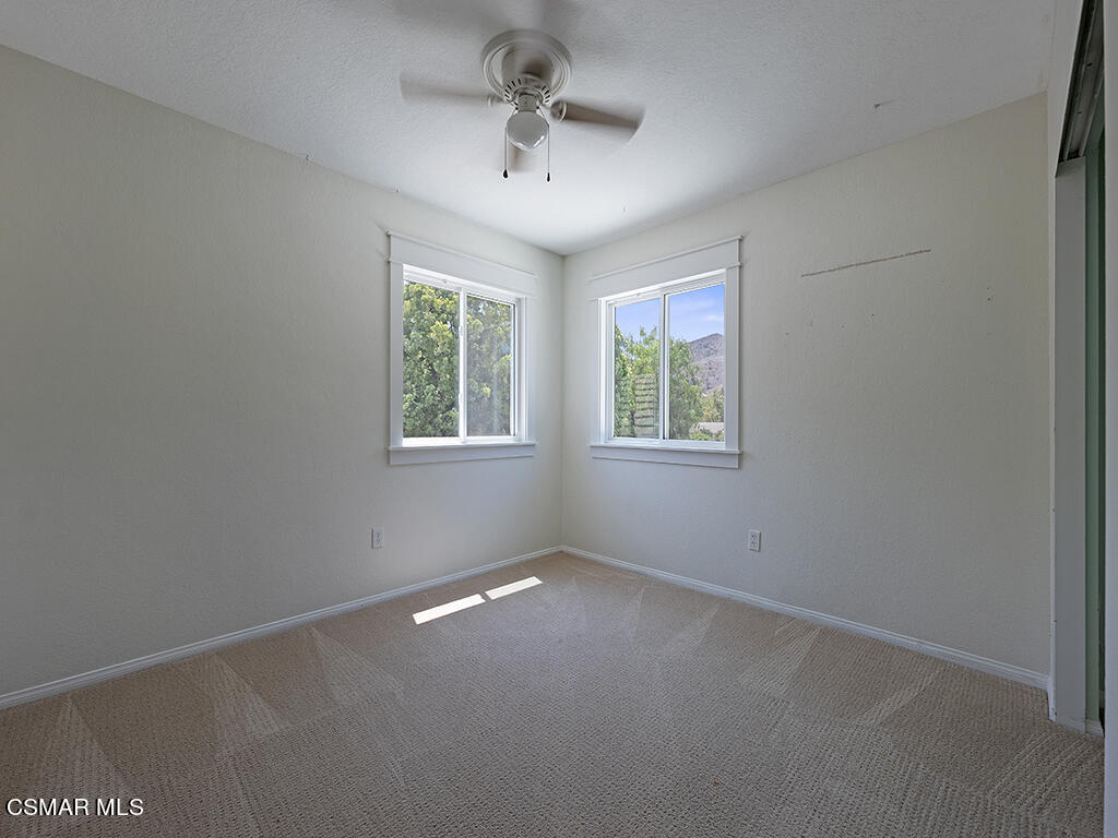 1902 Rambling Road Simi Valley, CA 93065 - Photo 43 of 67 an empty room with windows and ceiling fan