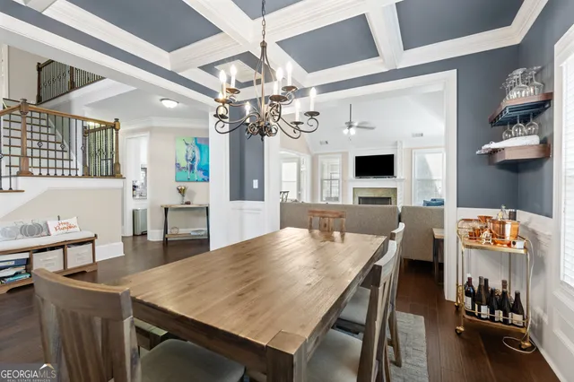 a view of a dining room with furniture and chandelier
