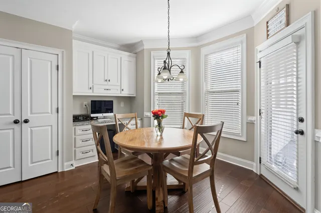a kitchen with stainless steel appliances granite countertop a refrigerator and white cabinets