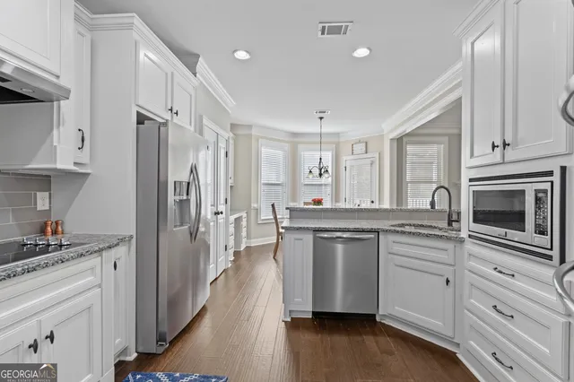 a bathroom with a granite countertop sink and a toilet