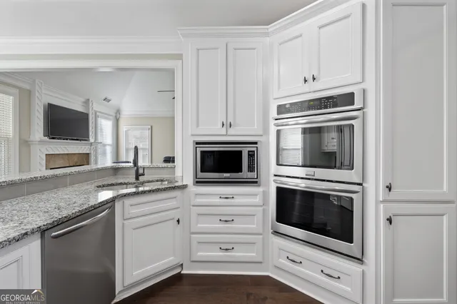 a bedroom with a bed chandelier and a couch