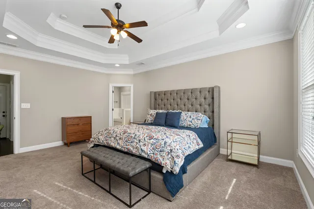 a bedroom with a bed a couch and a window