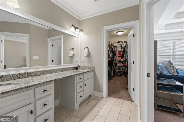 a en suite bathroom with a sink double vanity and mirror