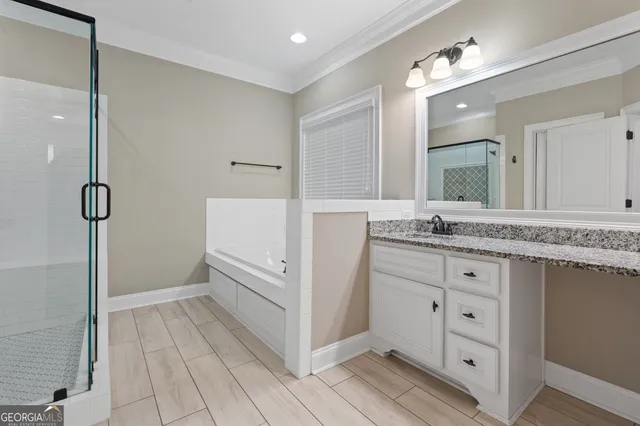 a bathroom with a bathtub and a shower