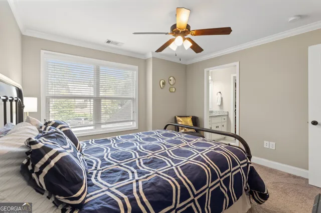 a bedroom with a large bed and a ceiling fan