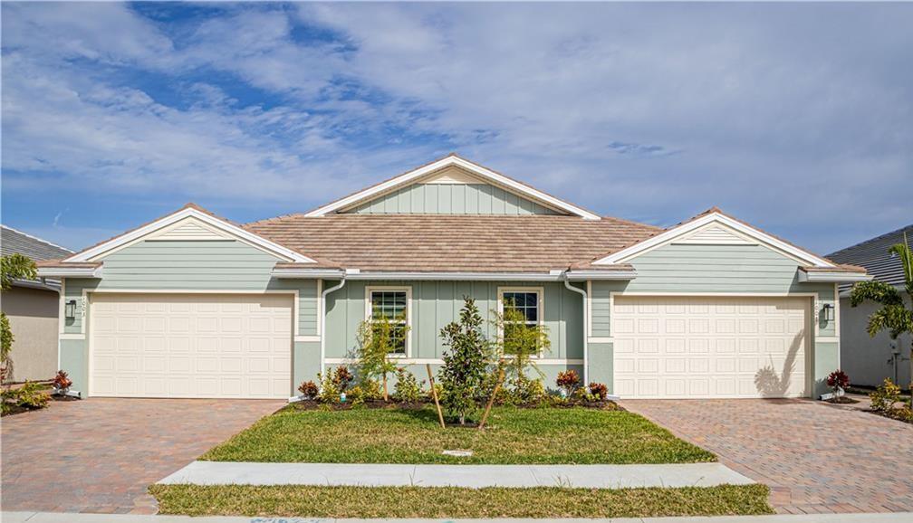 1015 Enbrook Loop Naples, FL 34114 - Photo 1 of 1 a front view of a house with a yard