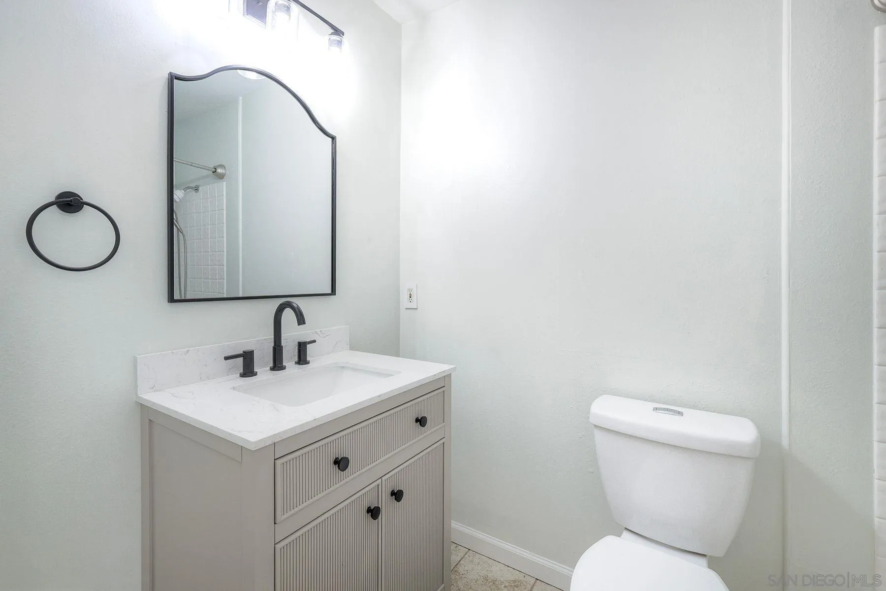 2371-75 Berry Street Lemon Grove, CA 91945 - Photo 11 of 56 a bathroom with a toilet sink and mirror