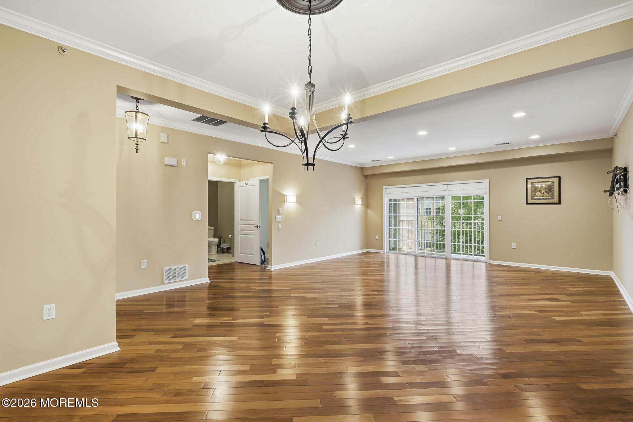 106 Potts Road Morganville, NJ 07751 - Photo 4 of 25 a view of an empty room with wooden floor and a window