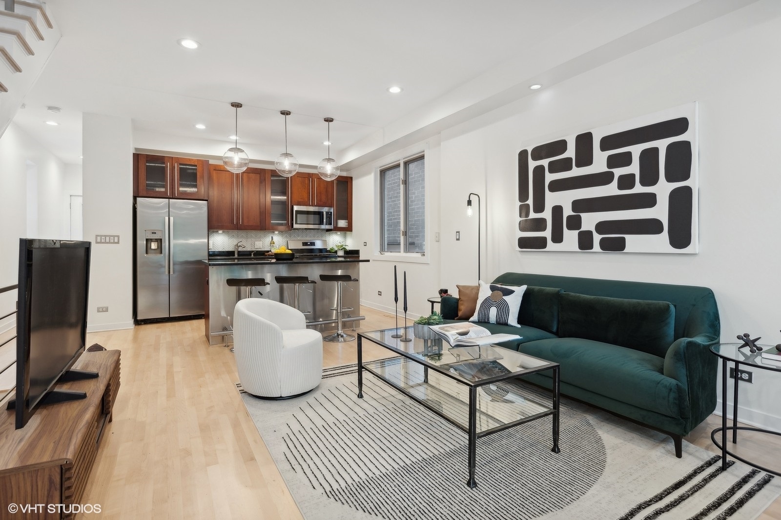 1834 West Rice Street, Unit A Chicago, IL 60622 - Photo 5 of 39 a living room with furniture a flat screen tv and kitchen view