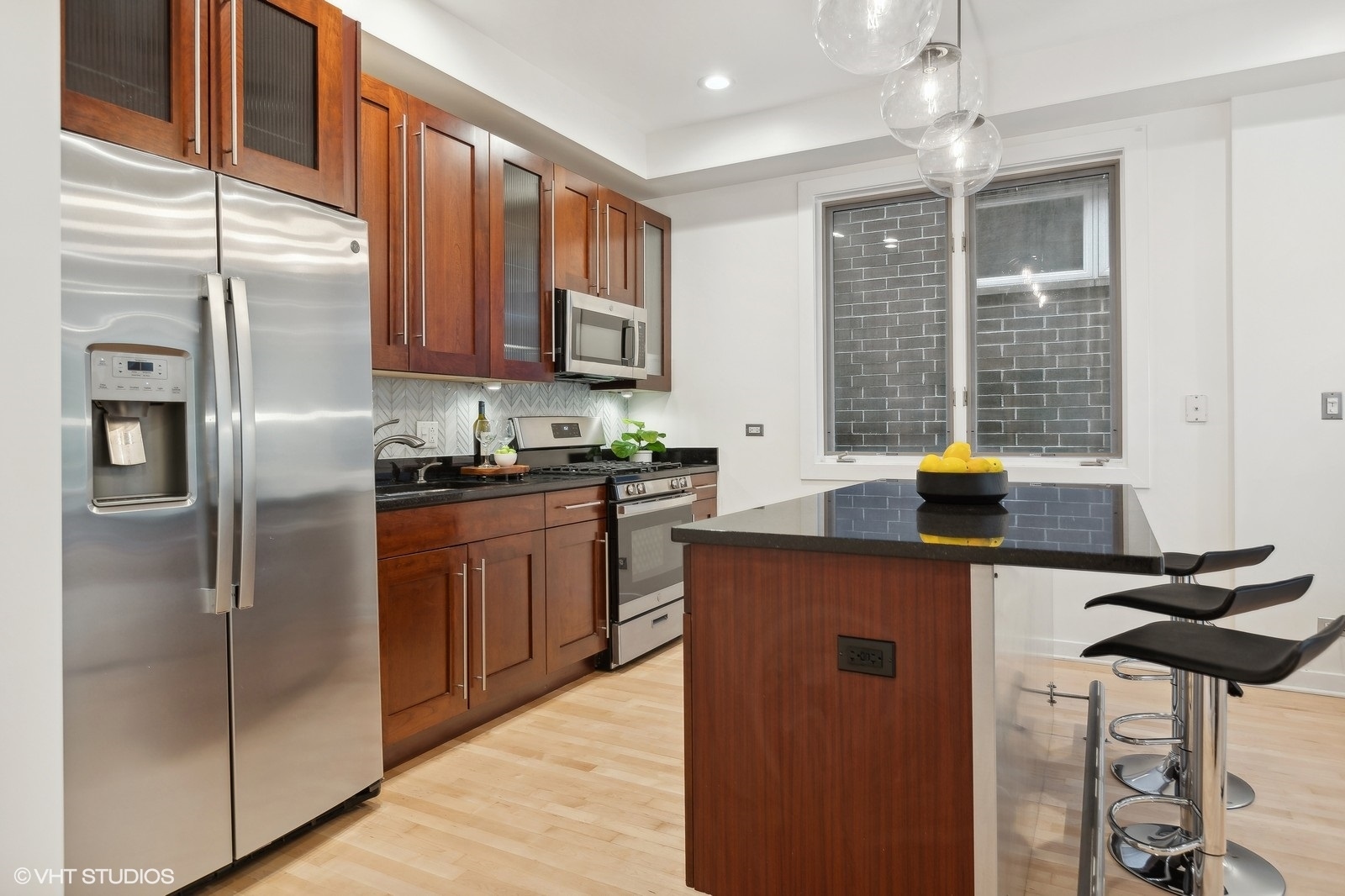 1834 West Rice Street, Unit A Chicago, IL 60622 - Photo 9 of 39 a kitchen with stainless steel appliances granite countertop a refrigerator a sink dishwasher a stove with wooden cabinets and floor