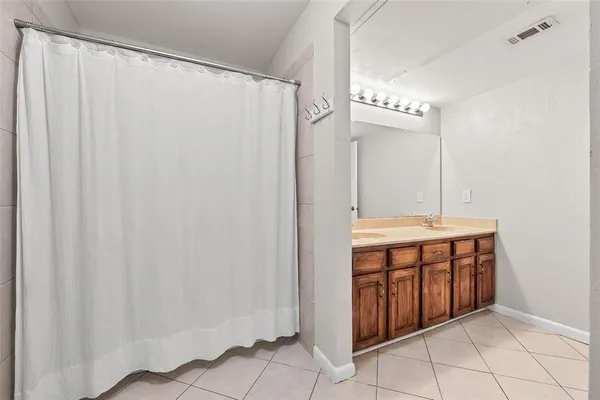 a bathroom with a double vanity sink and a mirror