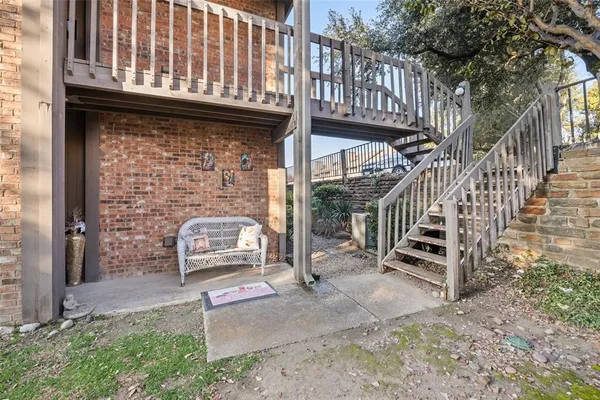 a view of a entrance with stairs and a yard