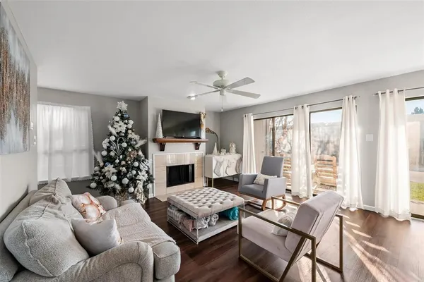 a living room with furniture large window and a fireplace