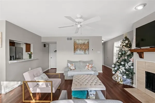 a living room with furniture a flat screen tv and a fireplace
