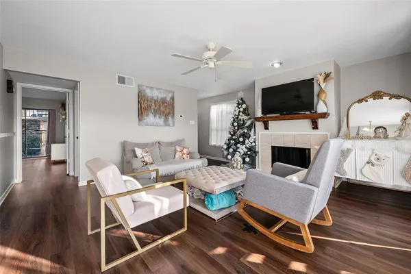 a living room with furniture a flat screen tv and a fireplace