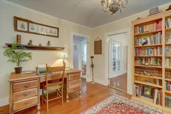 a view of a dining room with furniture wooden floor and a chandelier