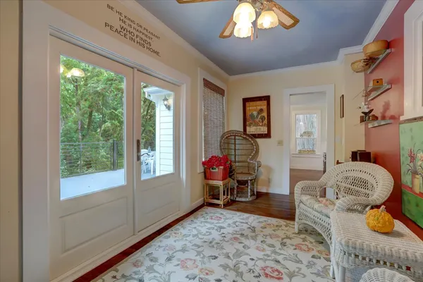 a view of a house with brick walls and a yard with potted plants