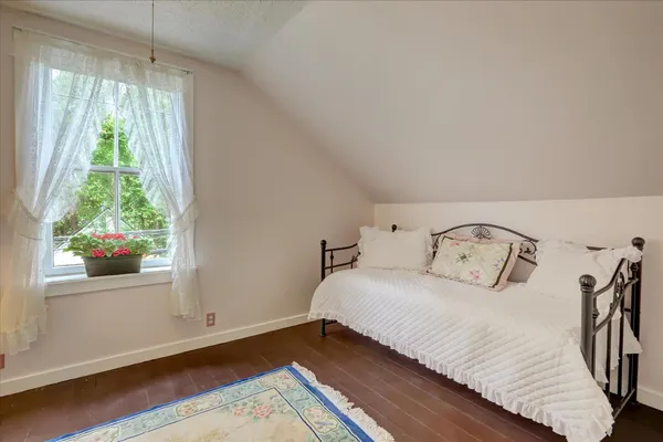 an aerial view of a house with swimming pool and garden space