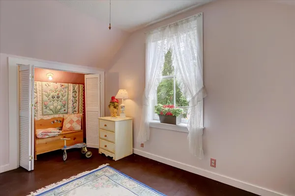 a front view of a house with a tree