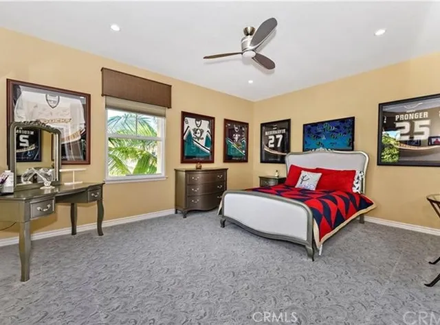 a bedroom with a large bed tv and a large window