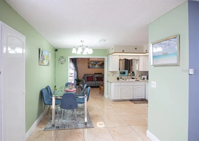 a kitchen with a dining table chairs and view kitchen
