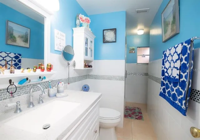 a bathroom with a sink toilet and mirror