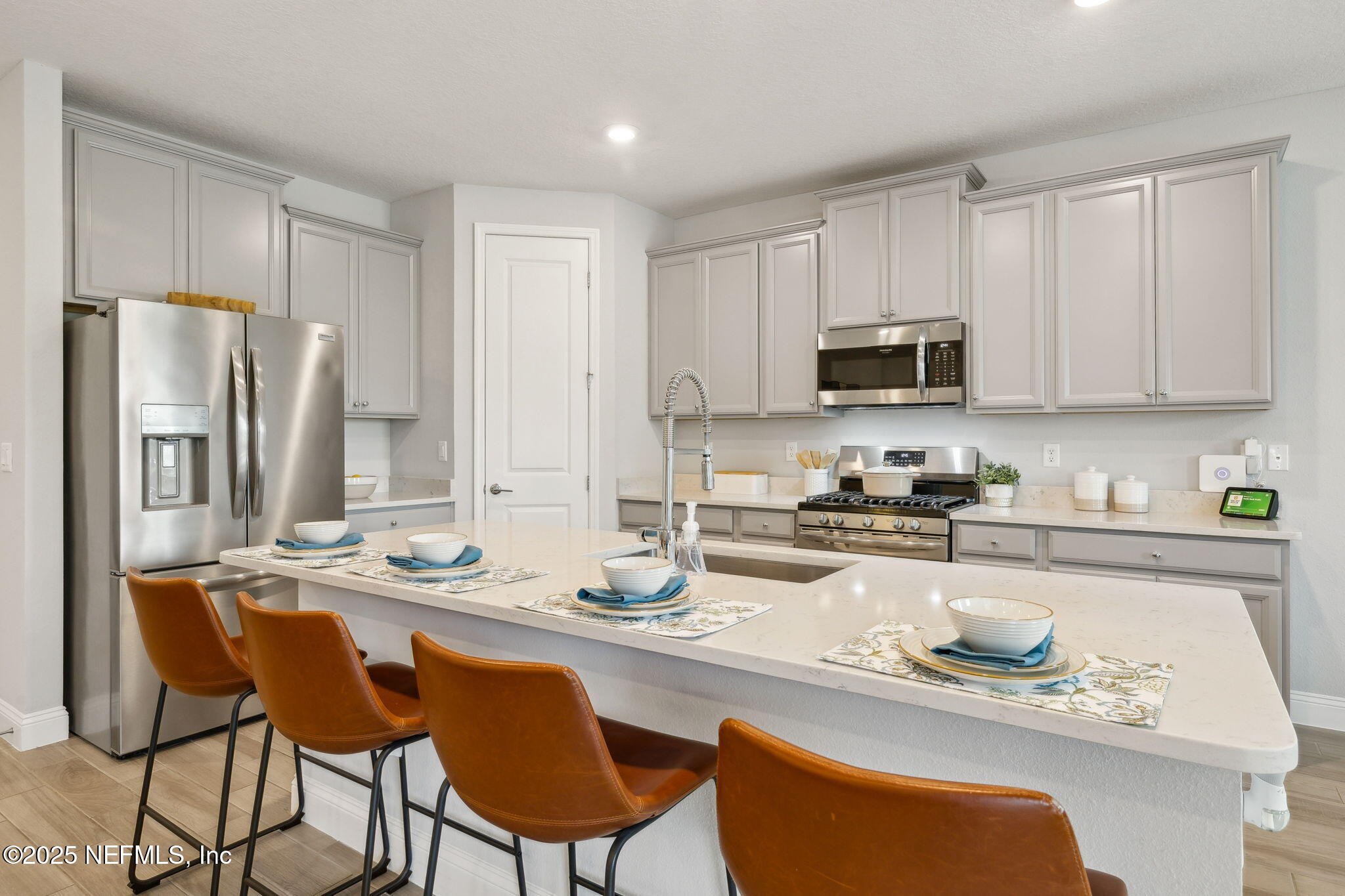 228 Killarney Avenue St. Johns, FL 32259 - Photo 11 of 64 a kitchen with stainless steel appliances granite countertop a stove top oven a refrigerator a sink and chairs