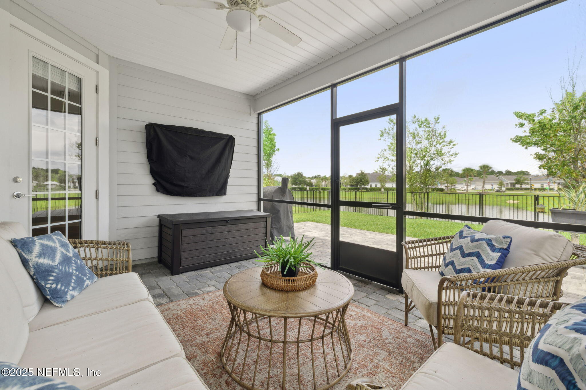 228 Killarney Avenue St. Johns, FL 32259 - Photo 34 of 64 a living room with furniture a flat screen tv and a floor to ceiling window