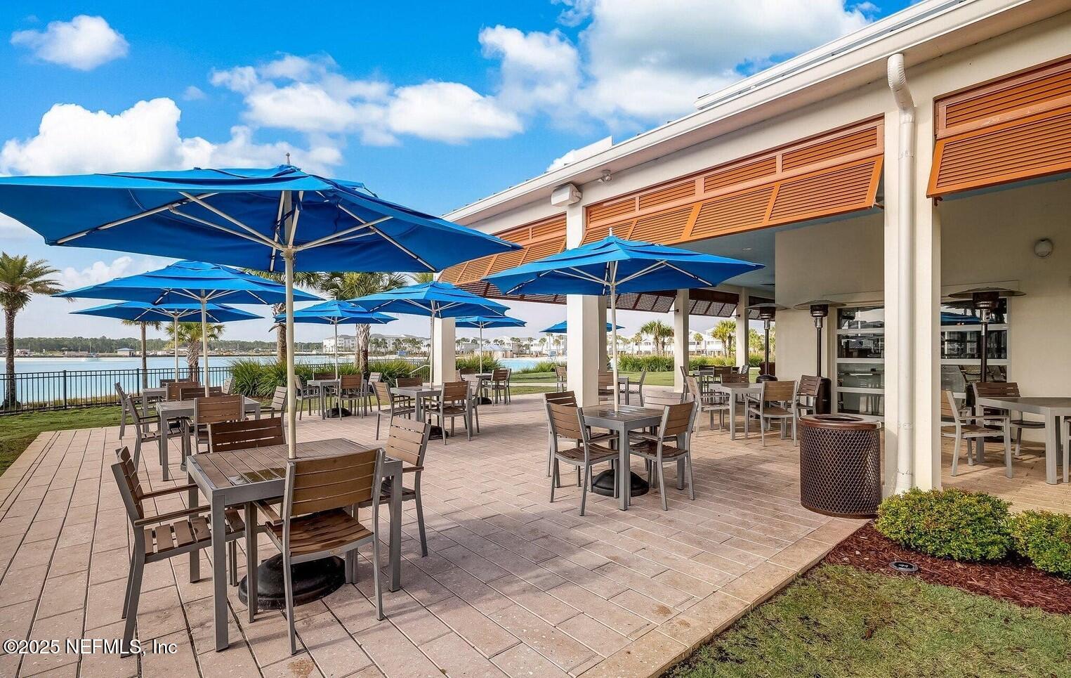 228 Killarney Avenue St. Johns, FL 32259 - Photo 46 of 64 a patio with a patio table and chairs