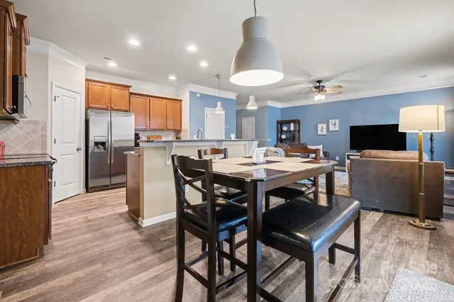 a view of a dining room with furniture and a wooden floor