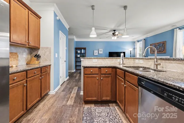 a kitchen with granite countertop wooden cabinets and a sink