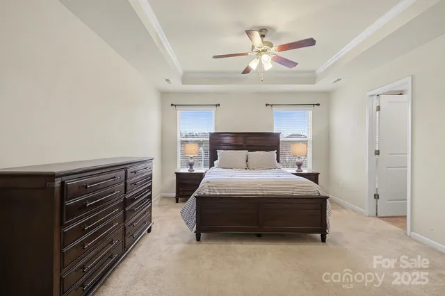 a bedroom with a bed and a ceiling fan