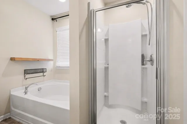 a bathroom with a tub and shower