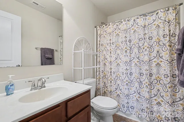 a bathroom with a sink toilet and a mirror