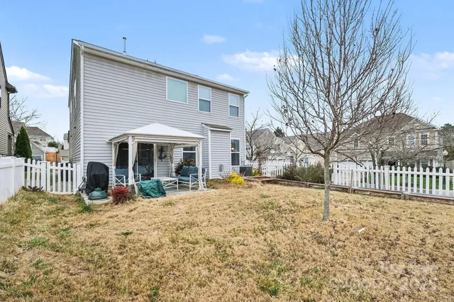 a view of a house with a yard covered in snow