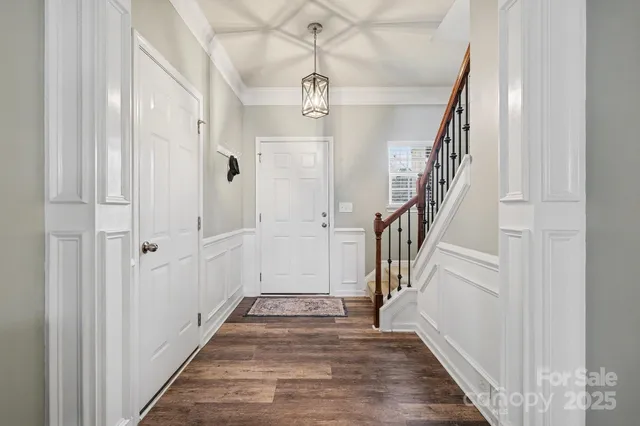 a view of a hallway with wooden floor and entryway