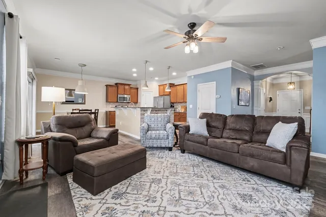 a living room with furniture and kitchen view