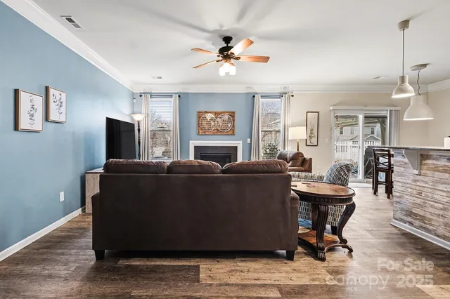 a living room with furniture a window and a chandelier