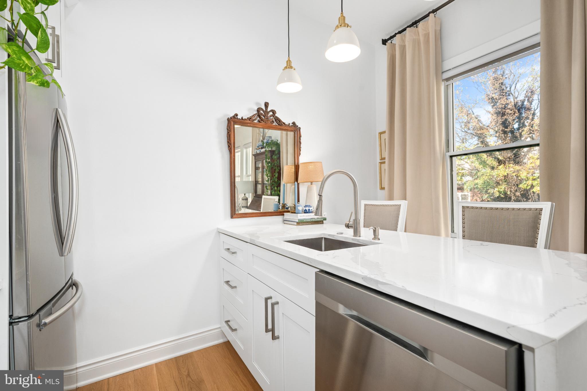 317 3rd Street Southeast, Unit 33 Washington, DC 20003 - Photo 17 of 26 a kitchen with a sink and a refrigerator