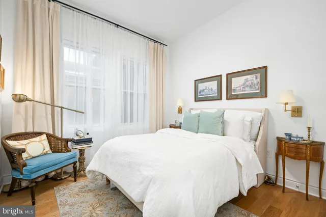 a bedroom with a bed and a large window