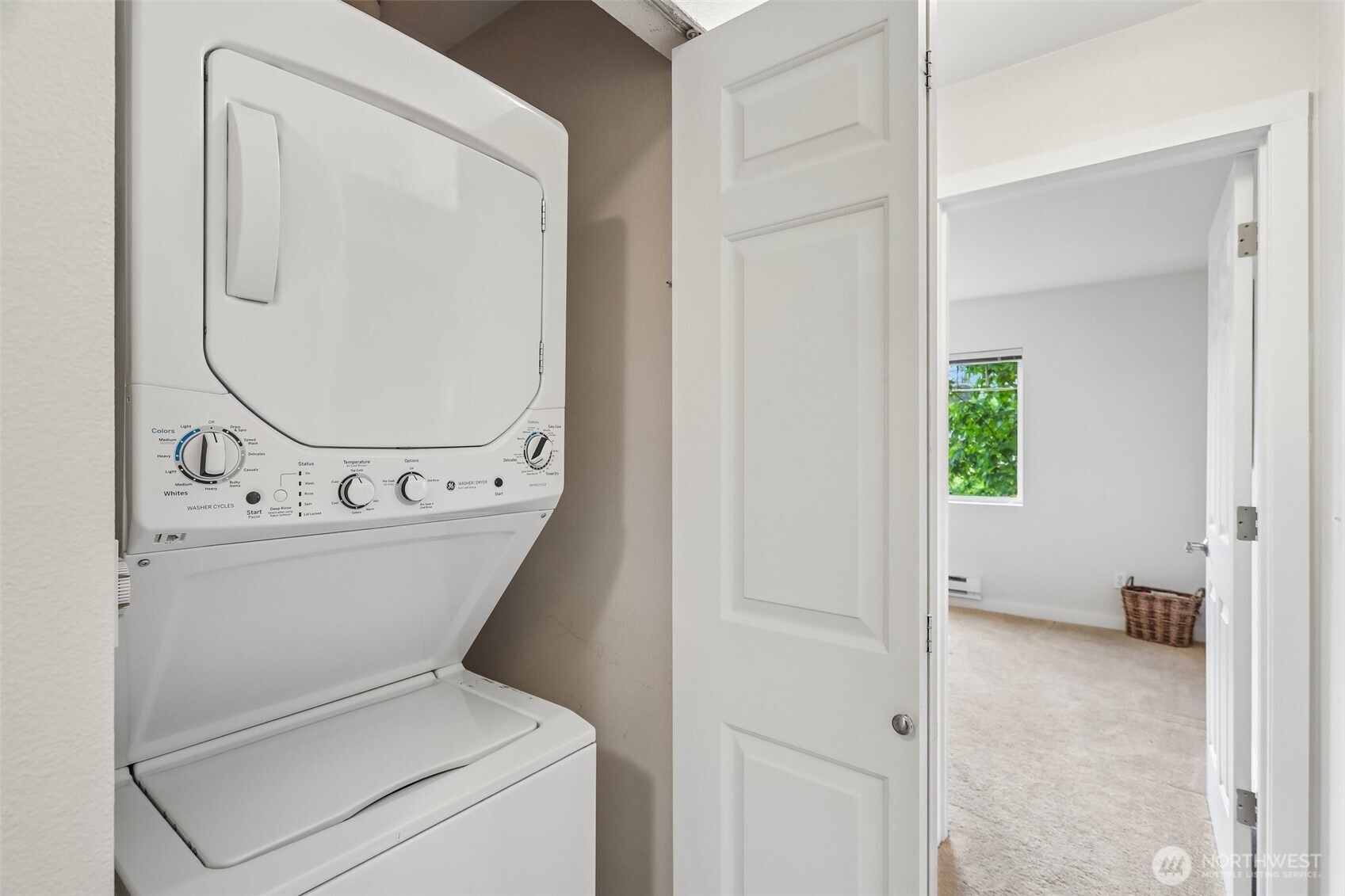 18930 Bothell Everett Highway, Unit E301 Bothell, WA 98012 - Photo 20 of 28 a view of washer and dryer with bathroom in the background
