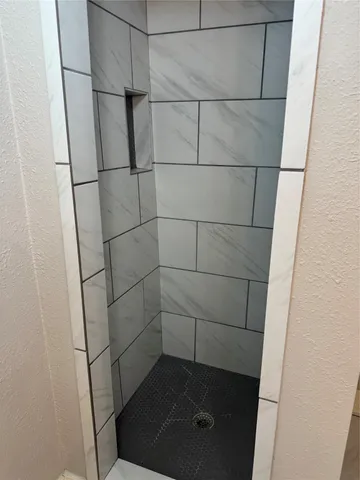 a bathroom with a glass shower door