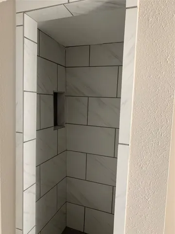 a bathroom with a glass shower door