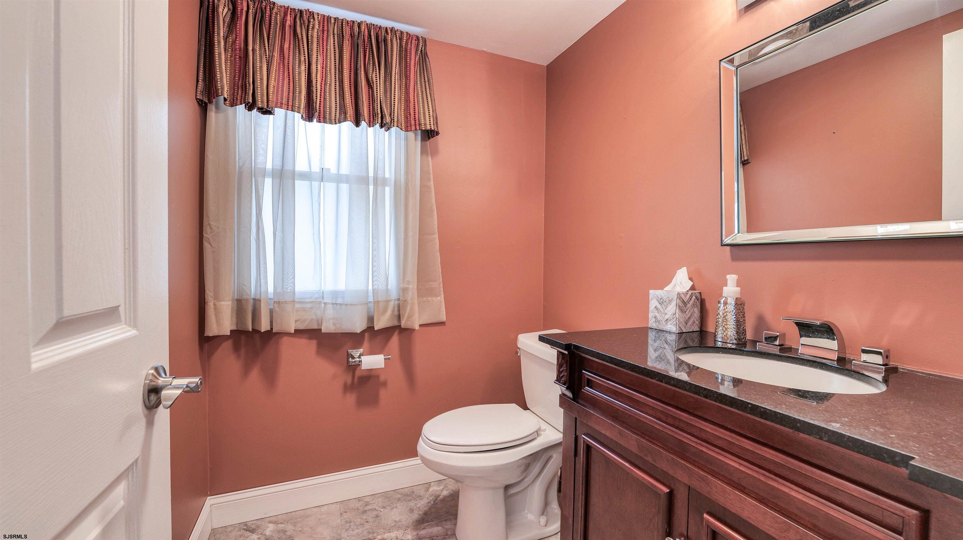 209 Reed Road Absecon, NJ 08201 - Photo 12 of 57 a bathroom with a sink a toilet and shower curtain