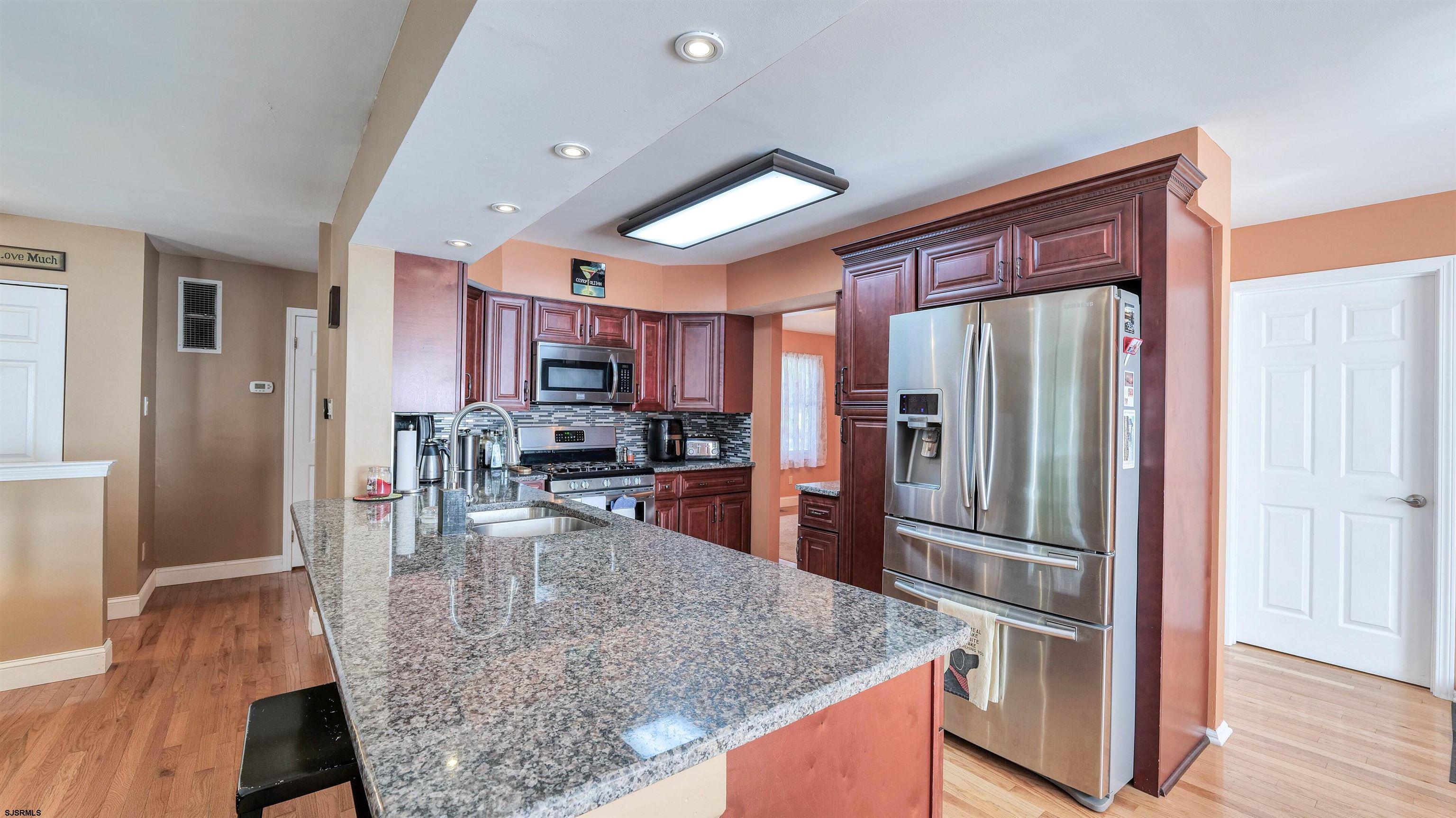 209 Reed Road Absecon, NJ 08201 - Photo 13 of 57 a kitchen with stainless steel appliances granite countertop a refrigerator and a stove