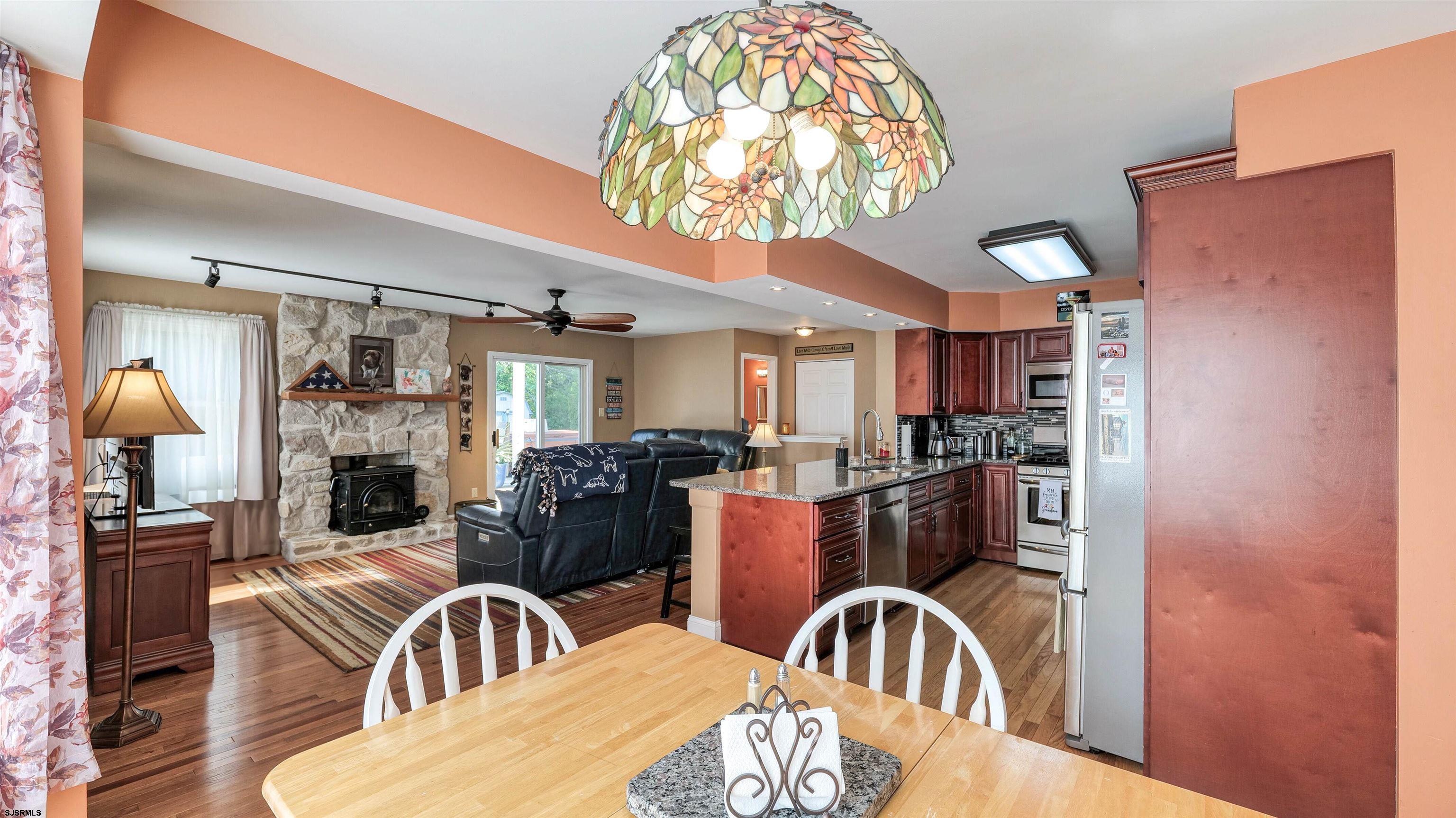 209 Reed Road Absecon, NJ 08201 - Photo 17 of 57 a view of a dining room with furniture and chandelier