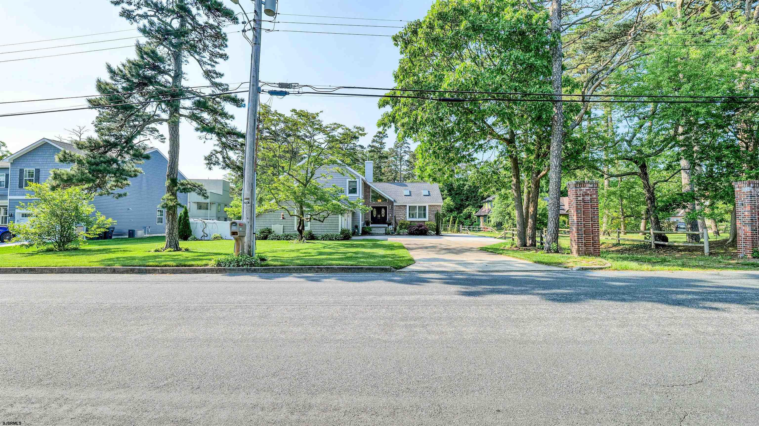 209 Reed Road Absecon, NJ 08201 - Photo 2 of 57 a view of a house with a big yard and large trees