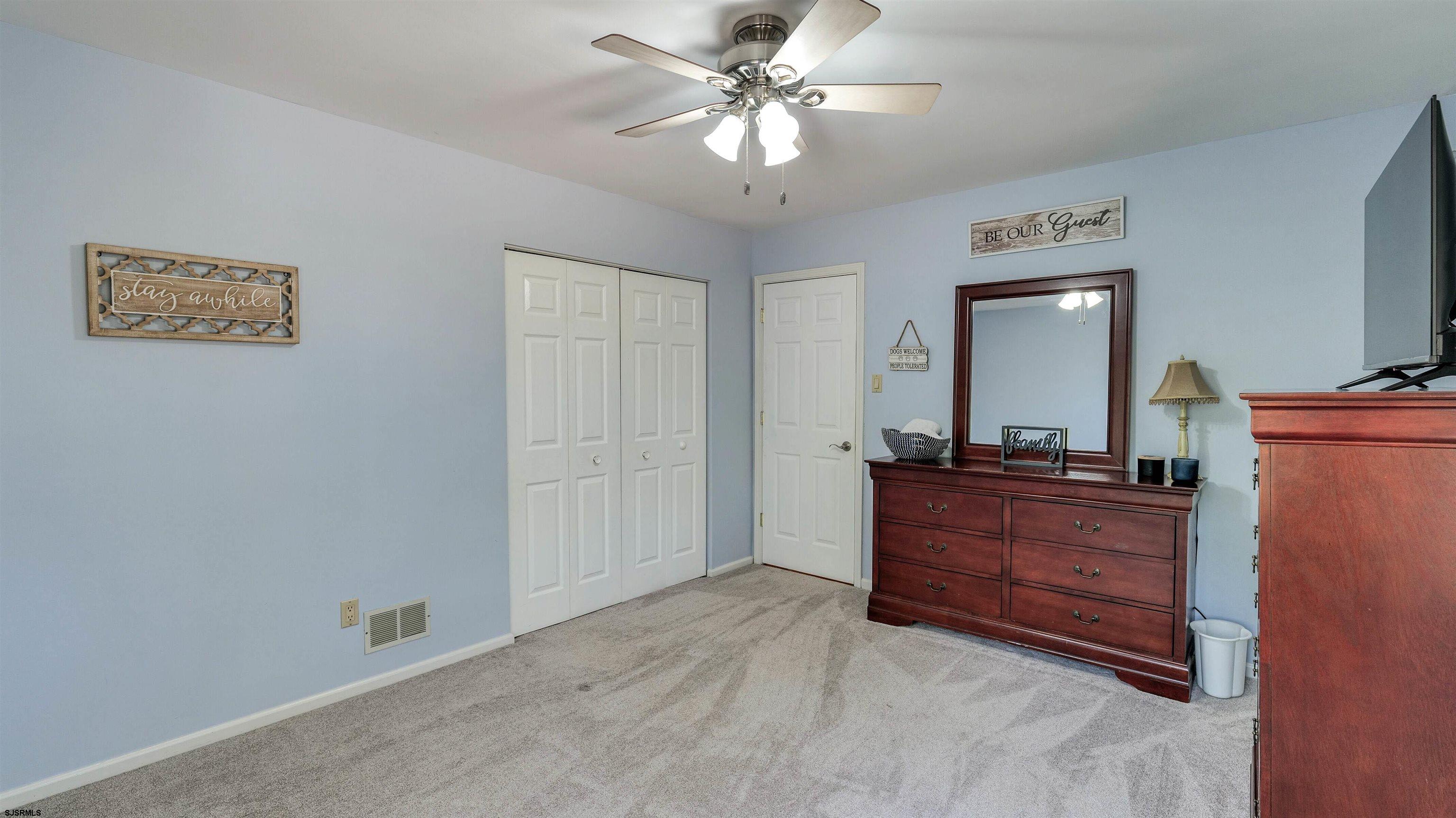 209 Reed Road Absecon, NJ 08201 - Photo 23 of 57 a room with a chandelier and a dresser