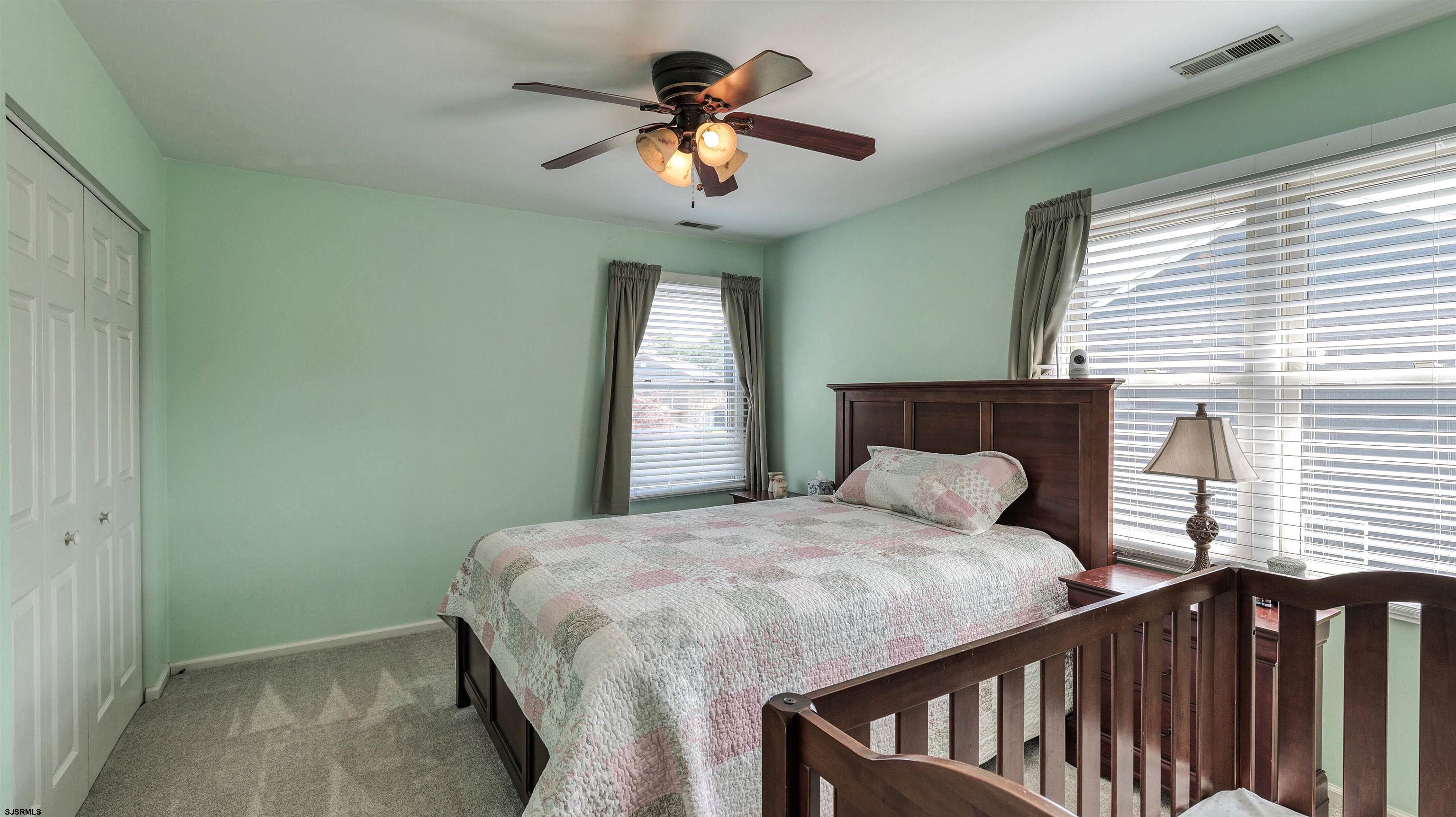209 Reed Road Absecon, NJ 08201 - Photo 24 of 57 a bedroom with a bed window and a chandelier